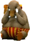 A small grey creature sitting in striped shorts with both hands over its eyes.